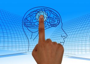 Grafika przedstawiająca głowę z zarysem mózgi. Mózg jest przyciskany przez palec wskazujący ludzkiej dłoni, tak jak przyciska się przycisk on/off